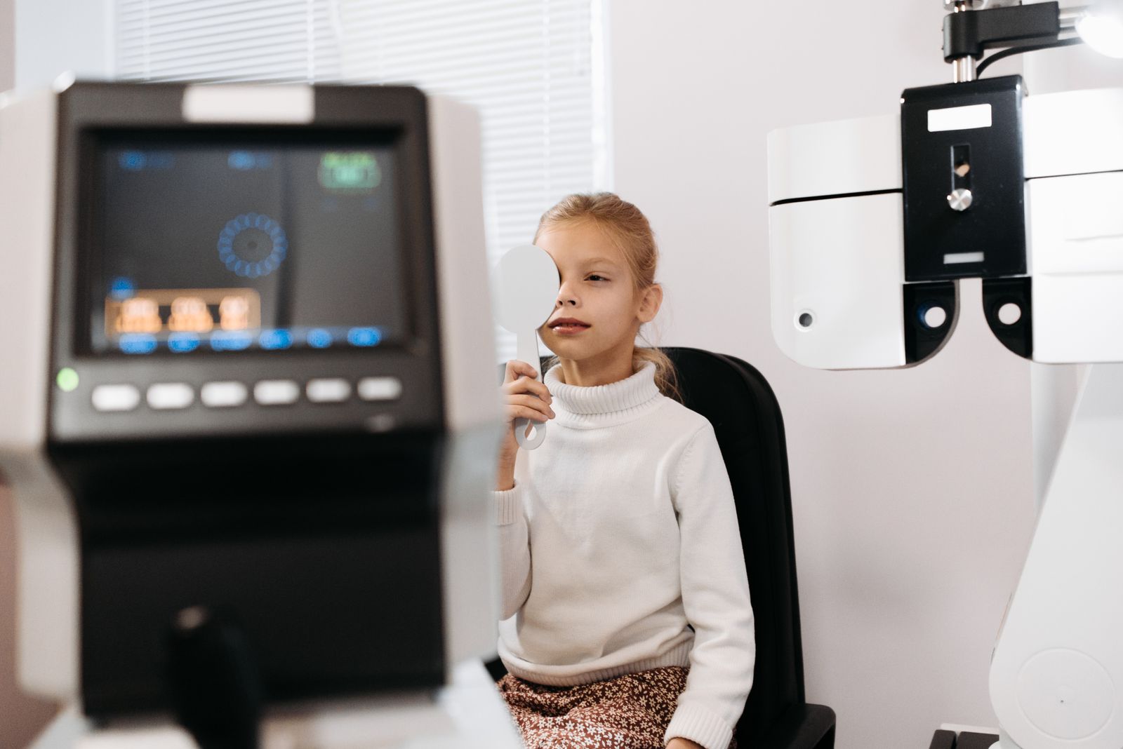 Child undergoing a vision test with an optometrist