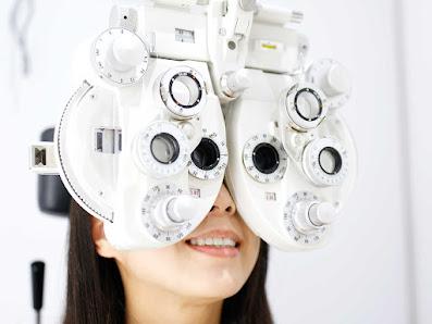 Patient having their eyes tested with a phoropter at Mississauga East Optical
